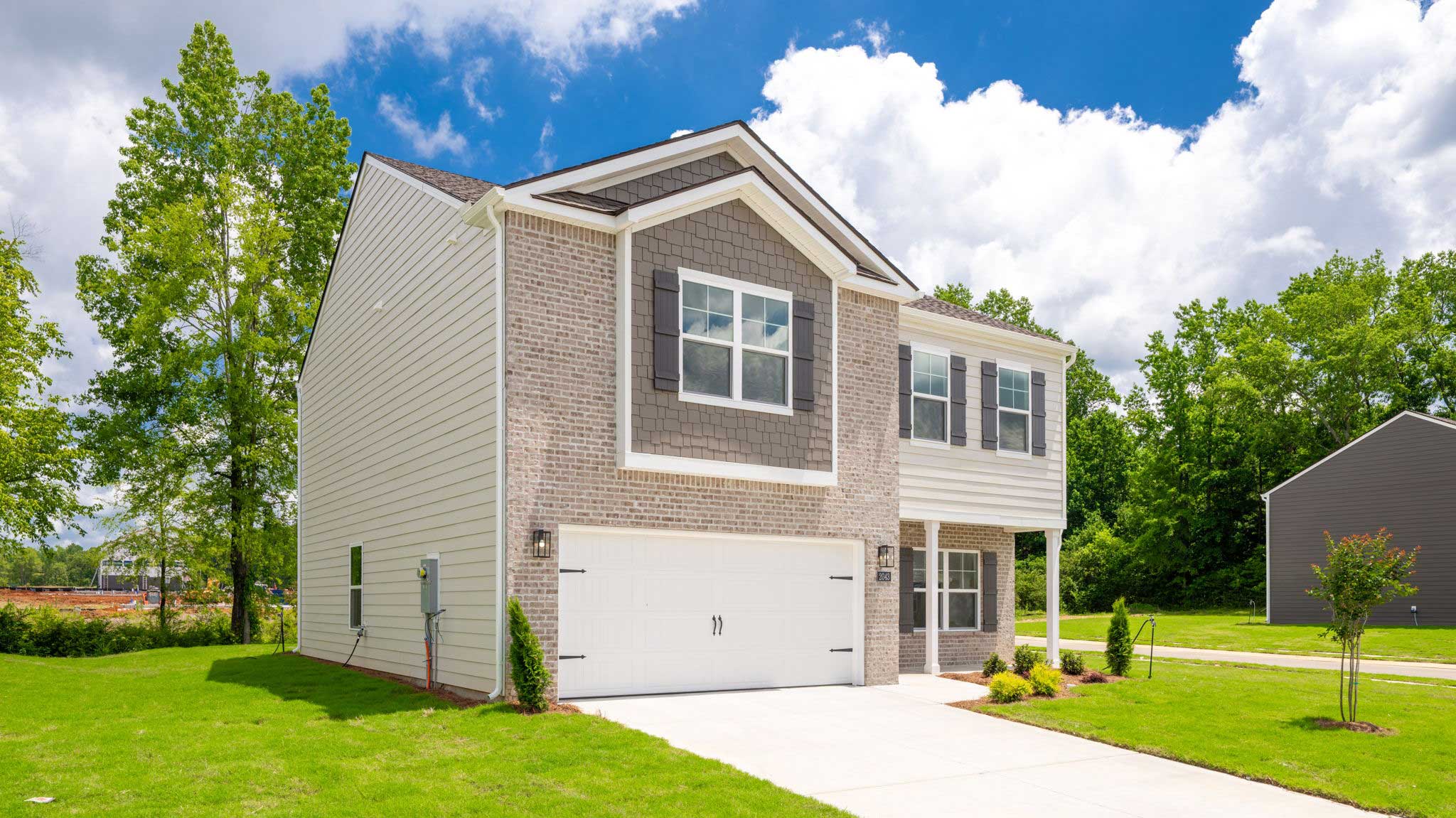 Two story home with two car garage and brick