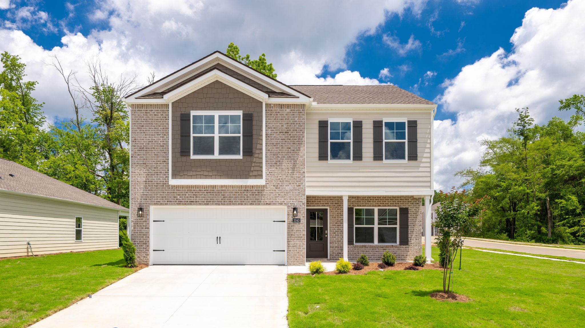 Two story home with two car garage and brick