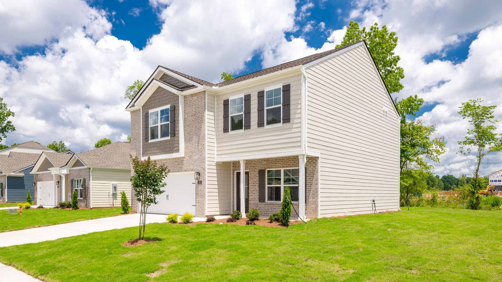 Two story home with two car garage and brick