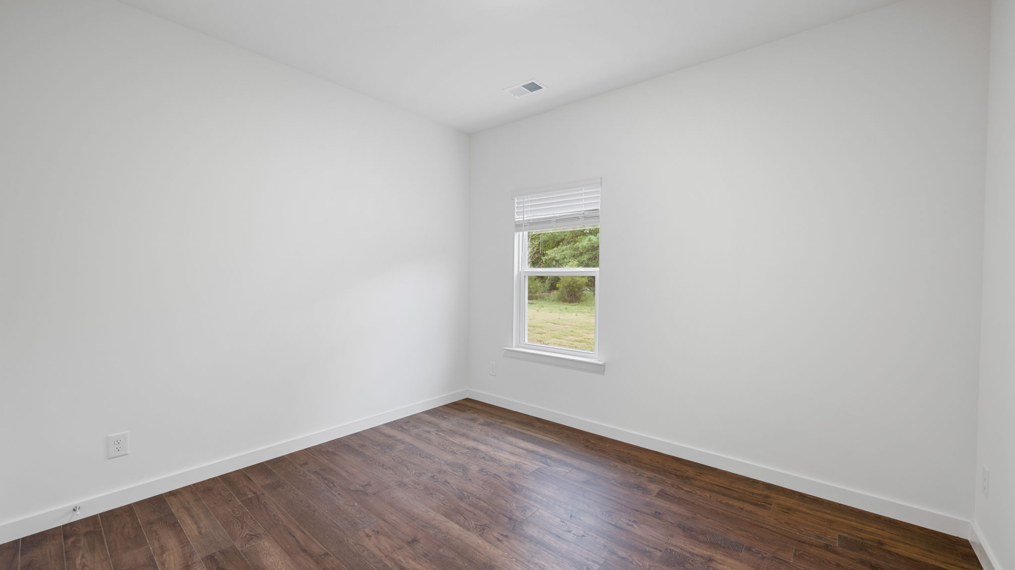 bedroom with solid lvp flooring and window