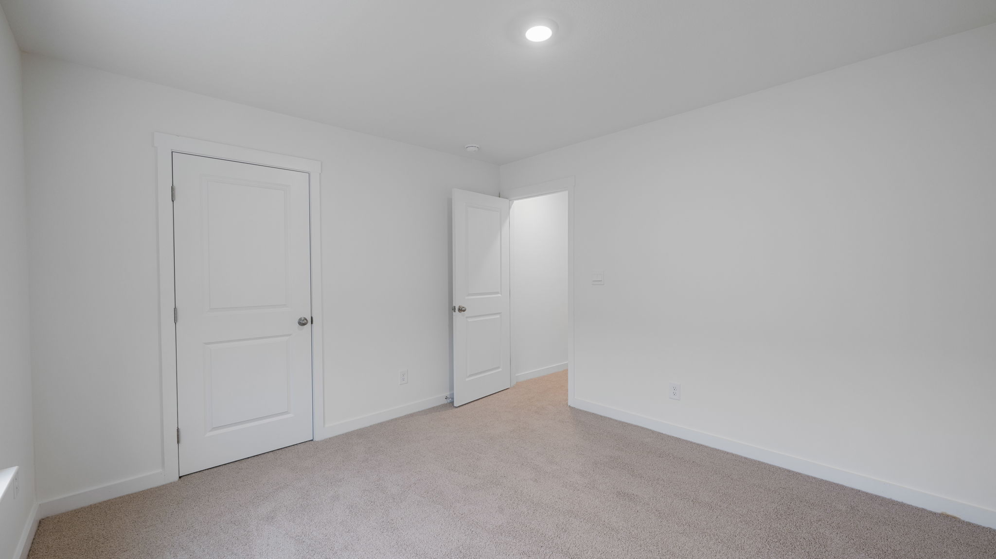 bedroom with carpet and open door