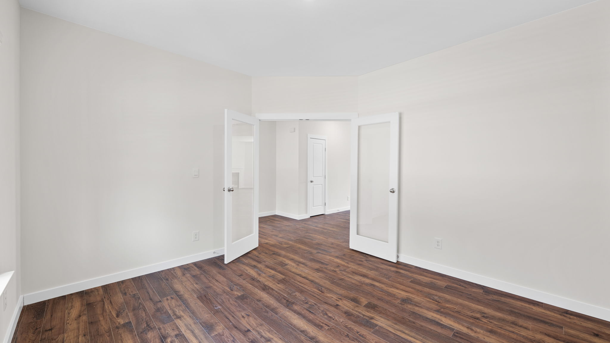 study area with solid flooring and french doors