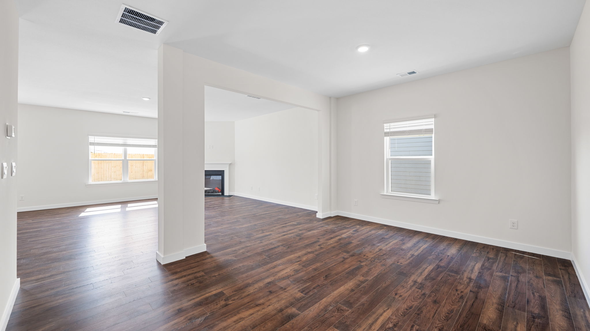 great room with solid flooring and fireplace