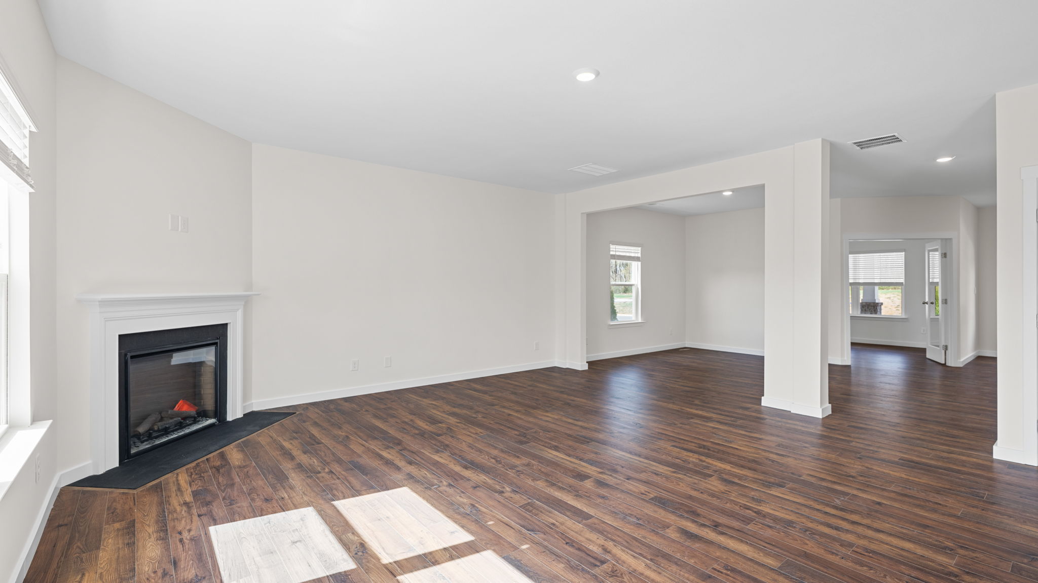 great room with solid flooring and fireplace