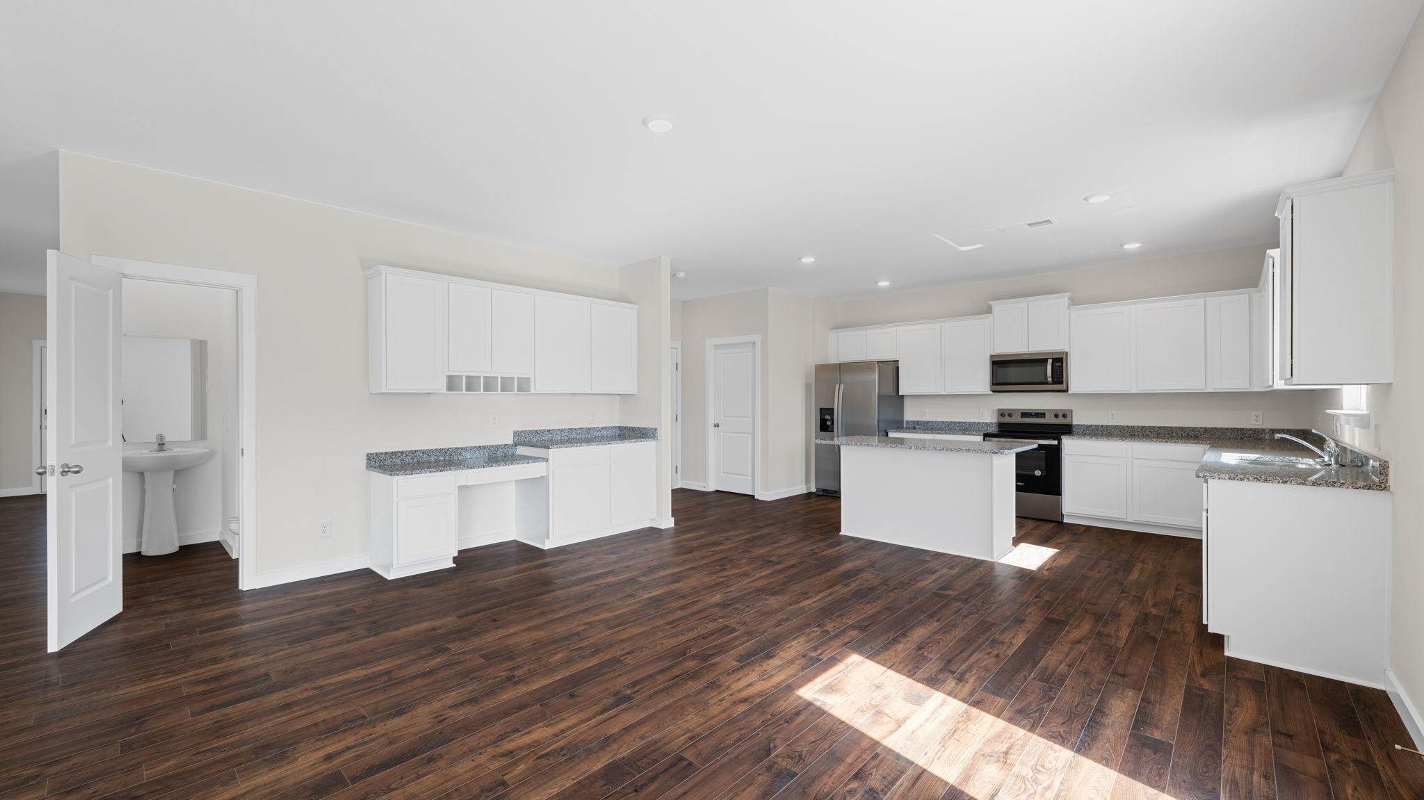 kitchen with island and appliances opens into great room