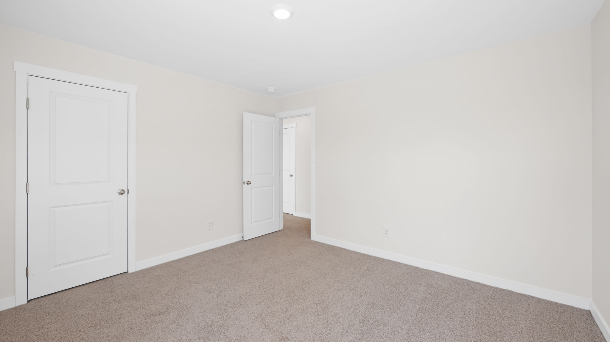 bedroom with carpet and open door