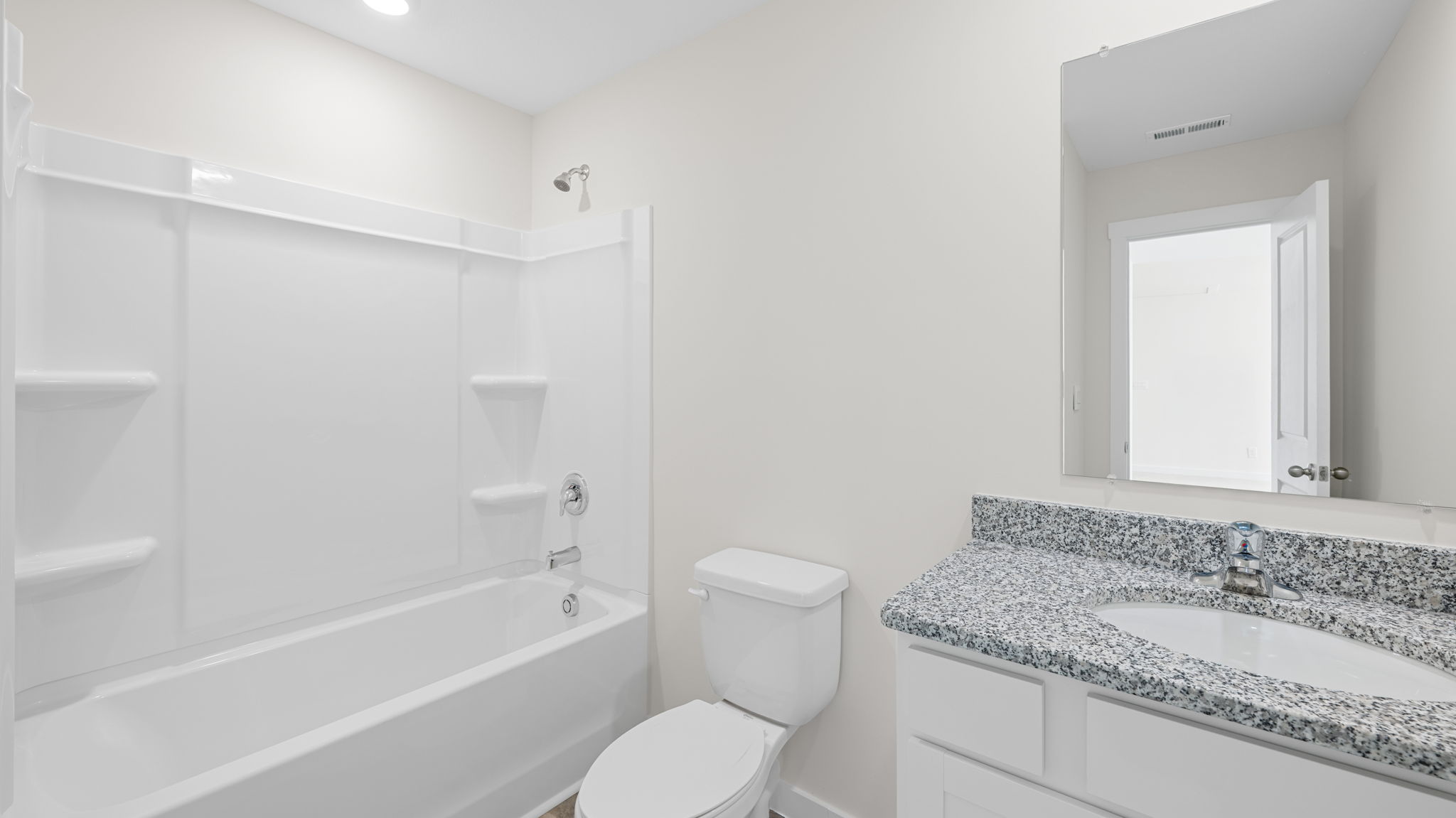 bathroom with vanity mirror and tub and shower combination