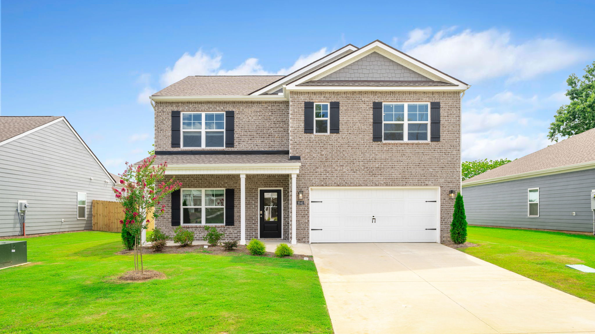 Two-story home with brick and two car garage