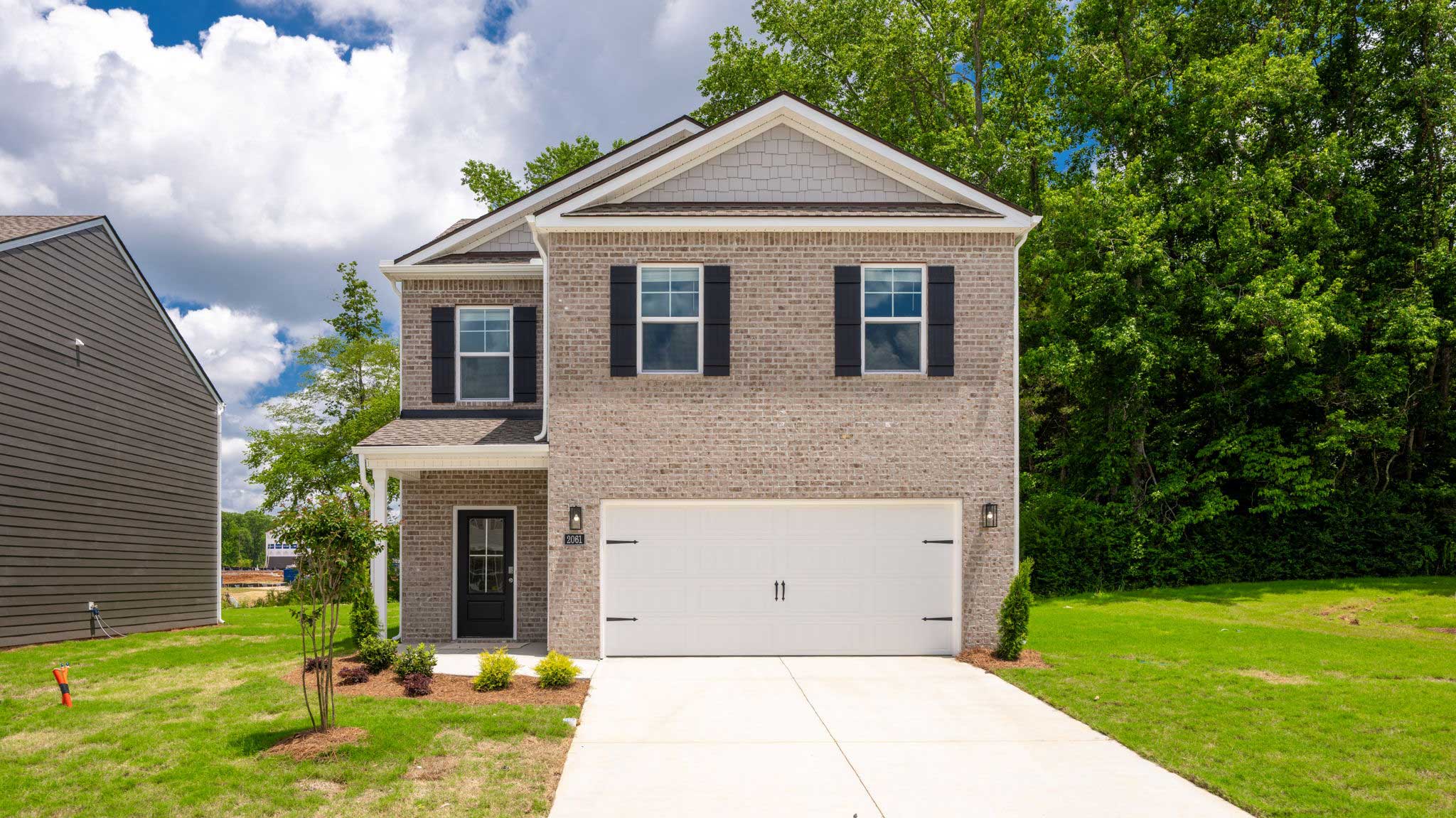 Two-story home with brick and two car garage