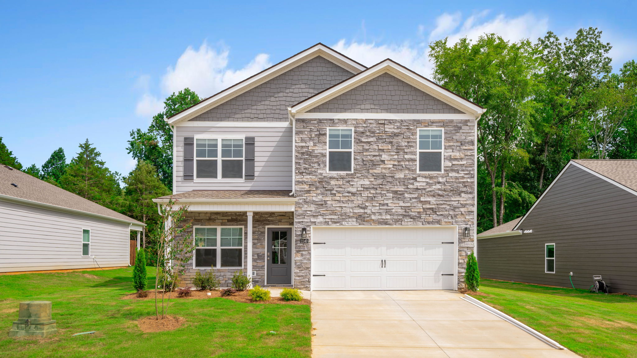 Two-story home with brick and two car garage