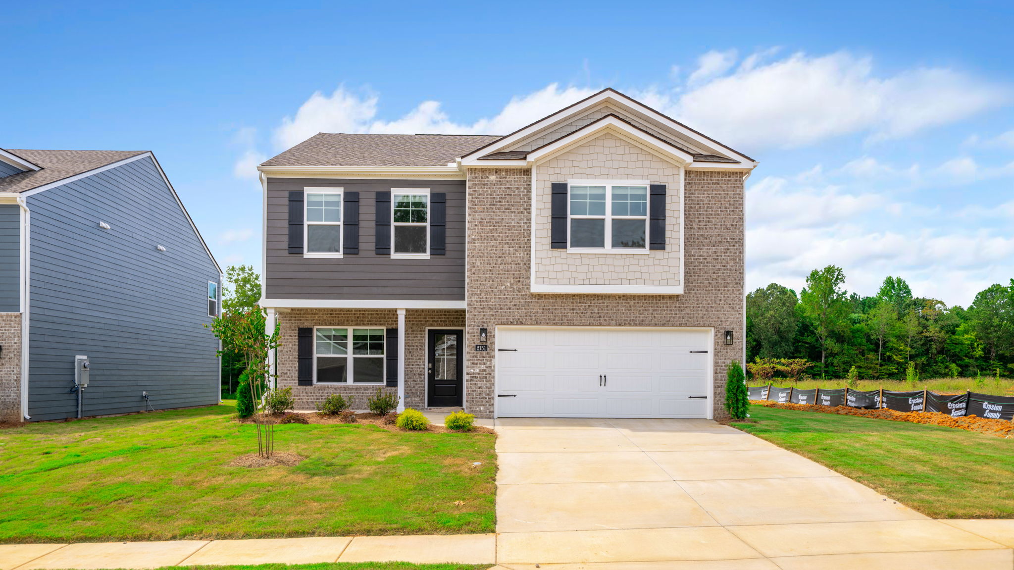 Two-story home with brick and two car garage