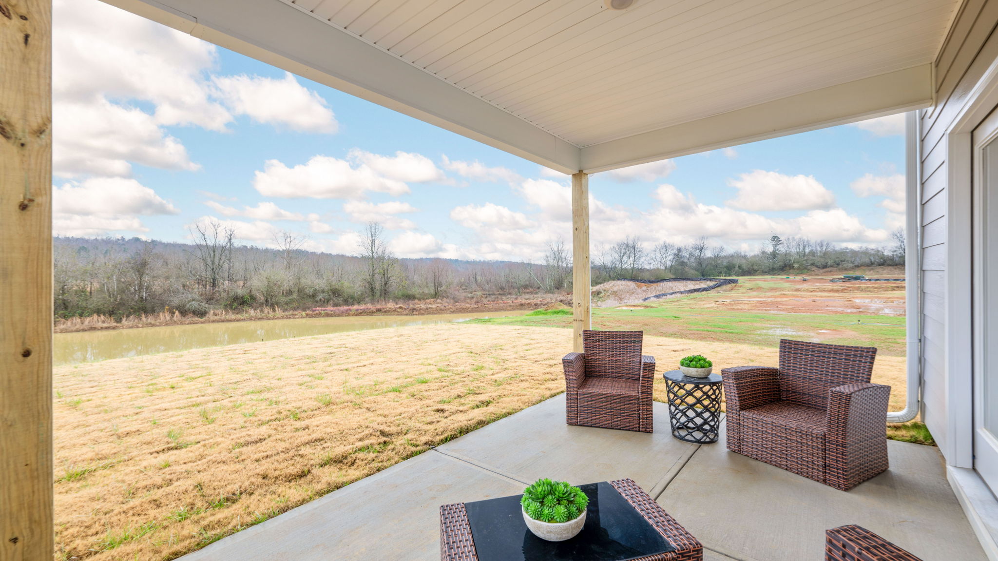 patio with furniture facing blue sky