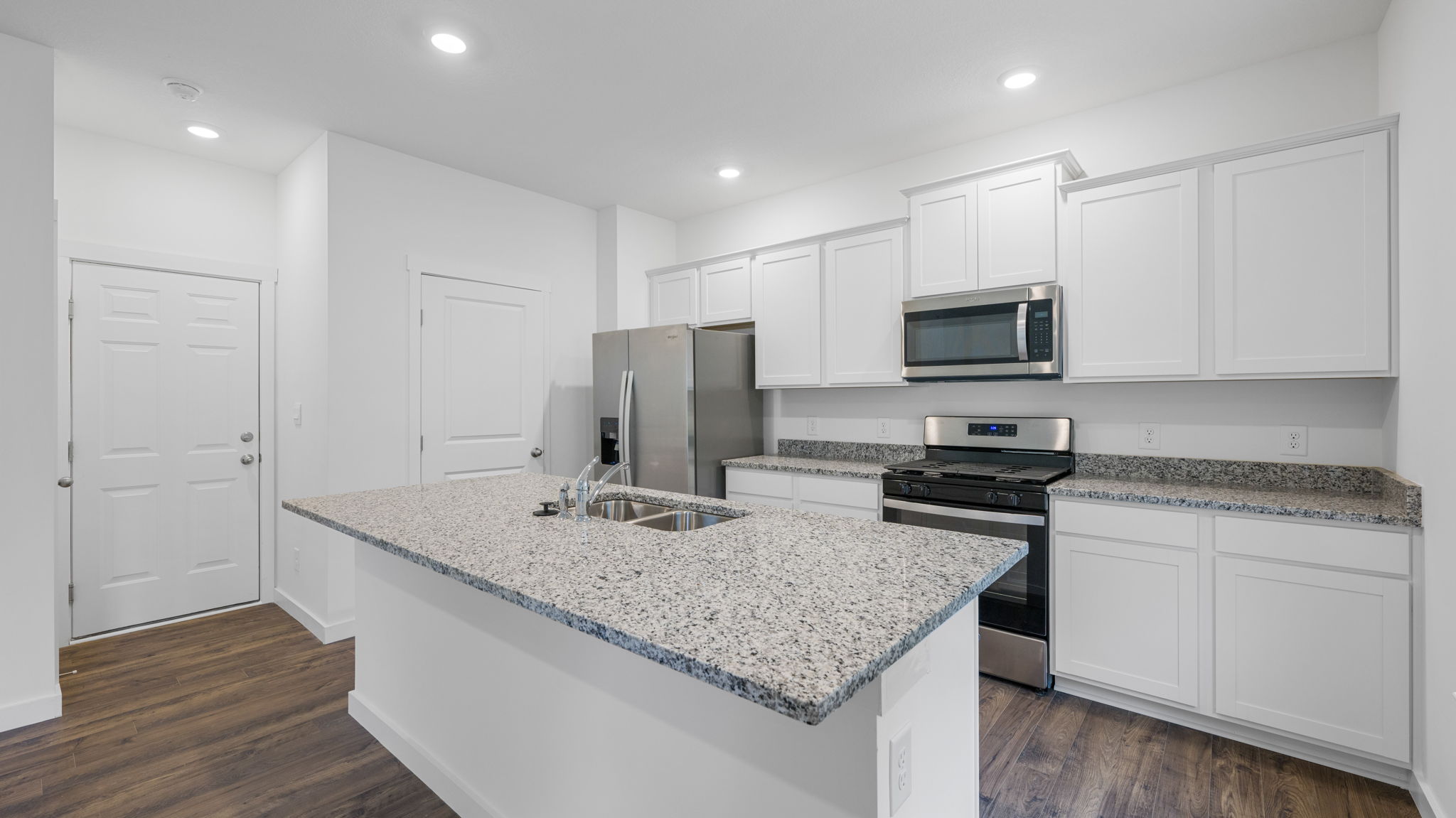open concept kitchen with stainless steel appliances and large island