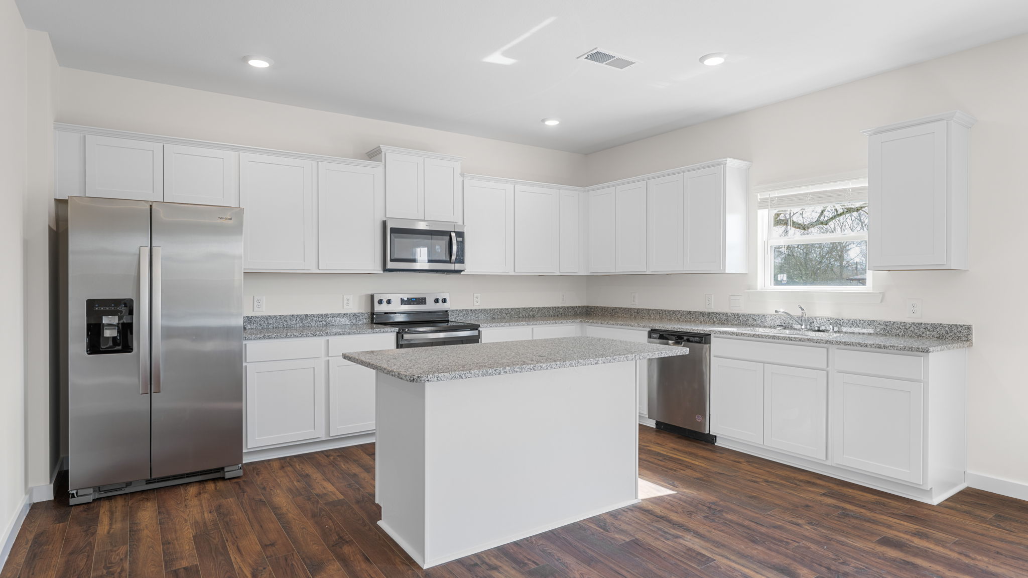 open concept kitchen with window and large island