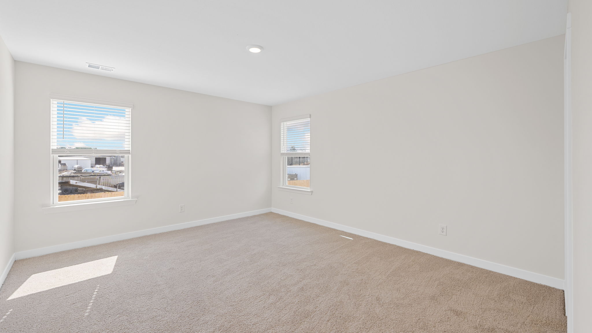 bedroom with two single windows and walk-in closet