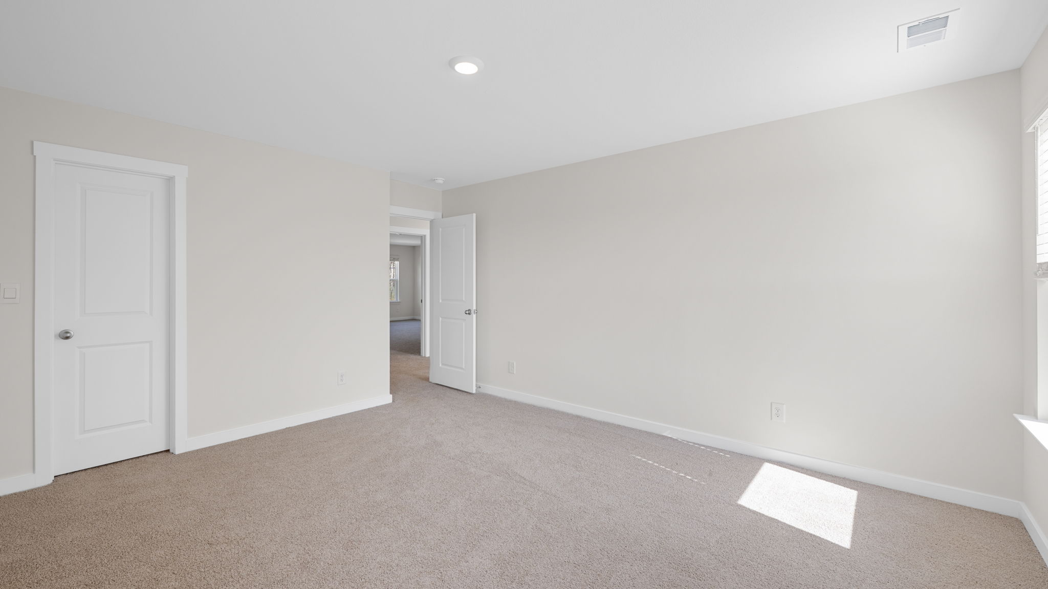 bedroom with two single windows and walk-in closet