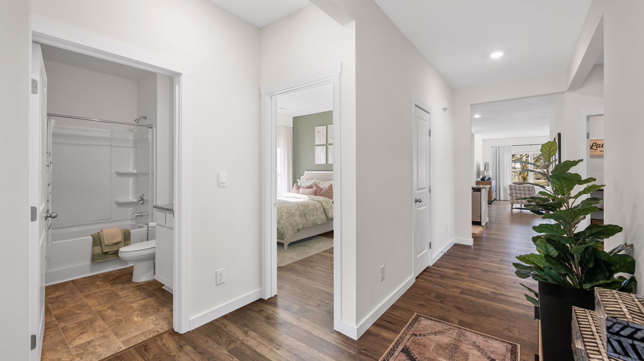 entryway hallway with rooms and bathroom to the left