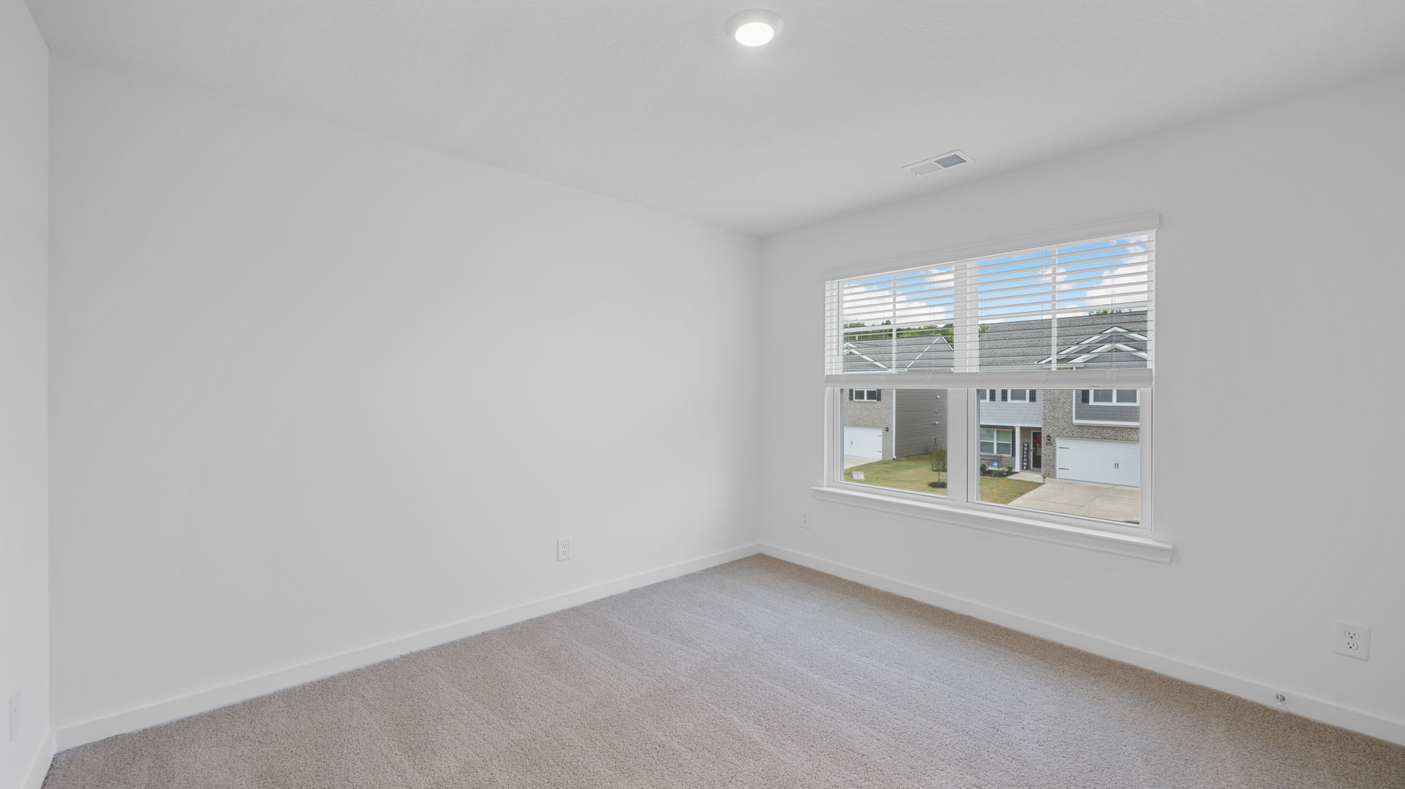 bedroom with double window and walk-in closet