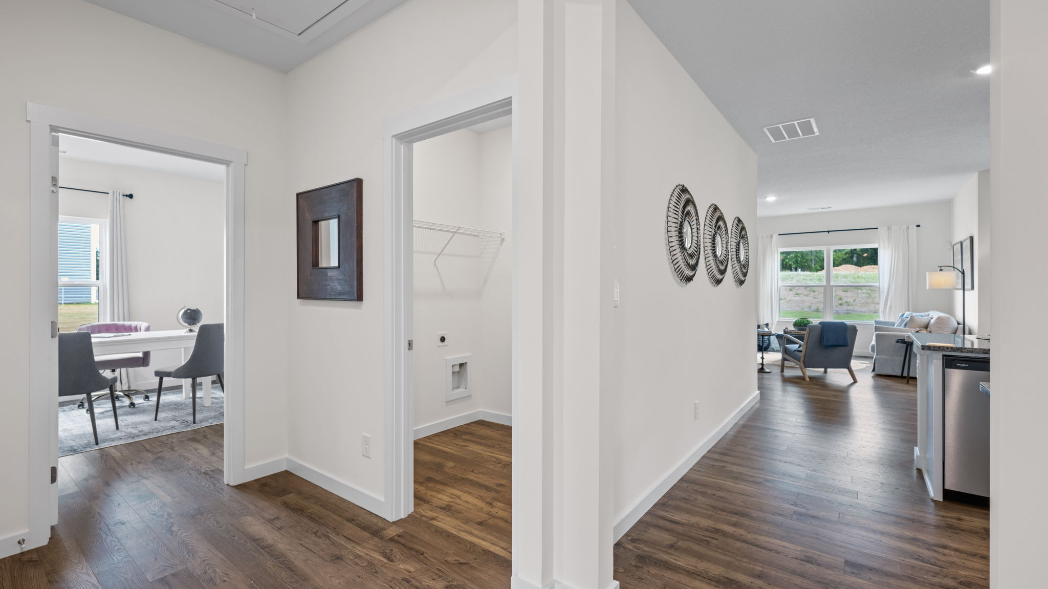 hallway with open doors and art on walls