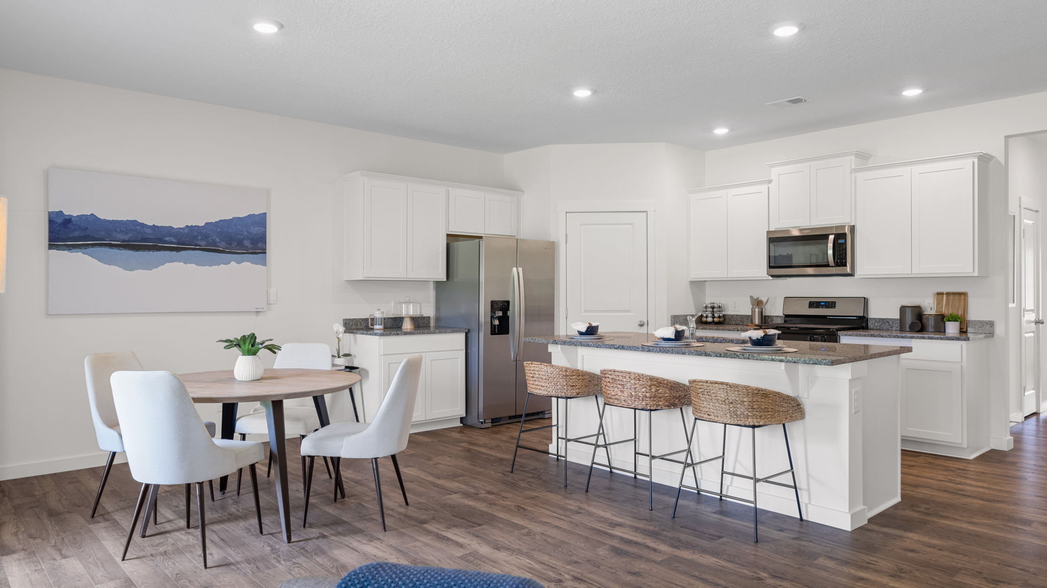 kitchen with island and three chairs