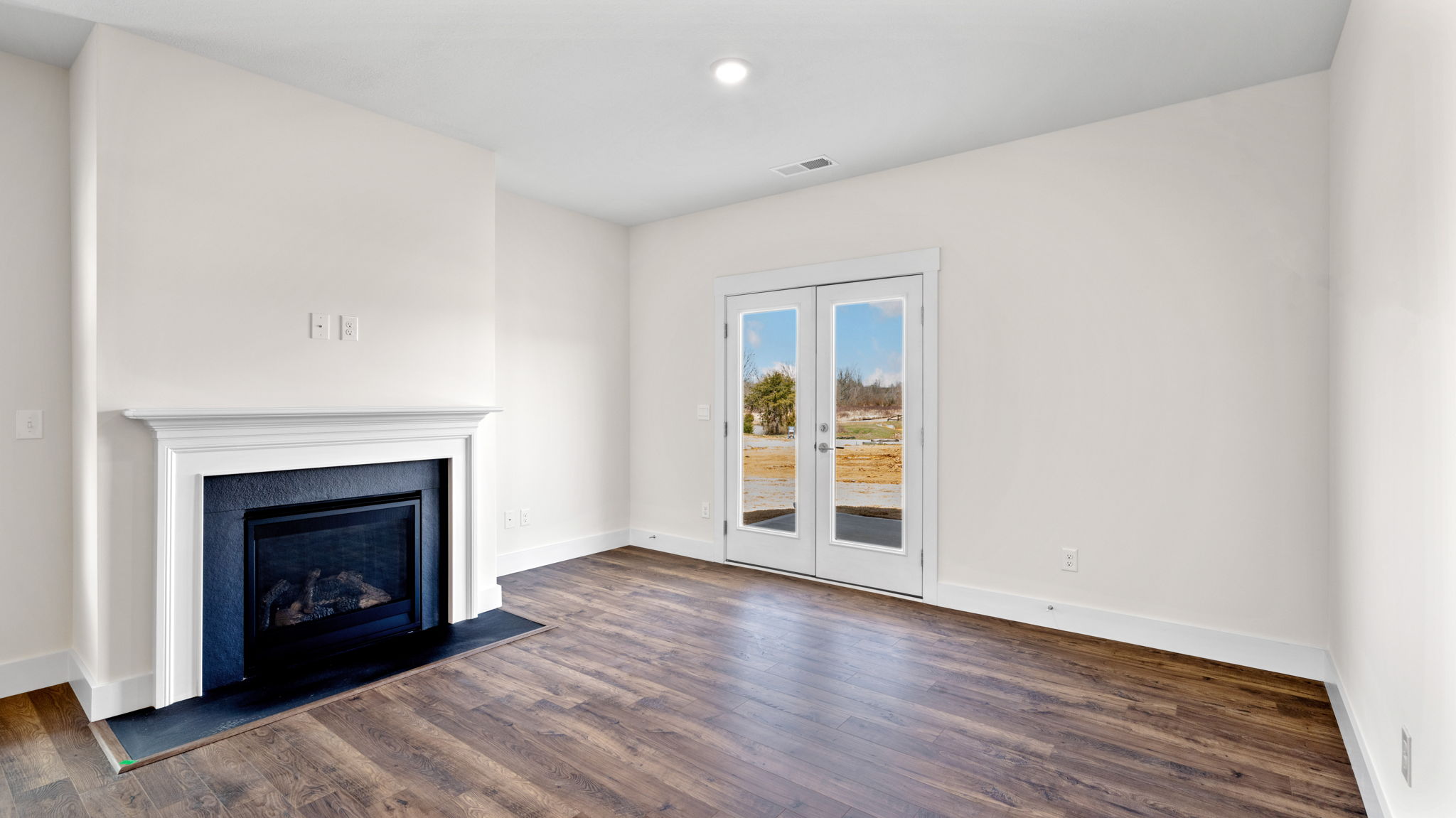 The fireplace has a white surround.
