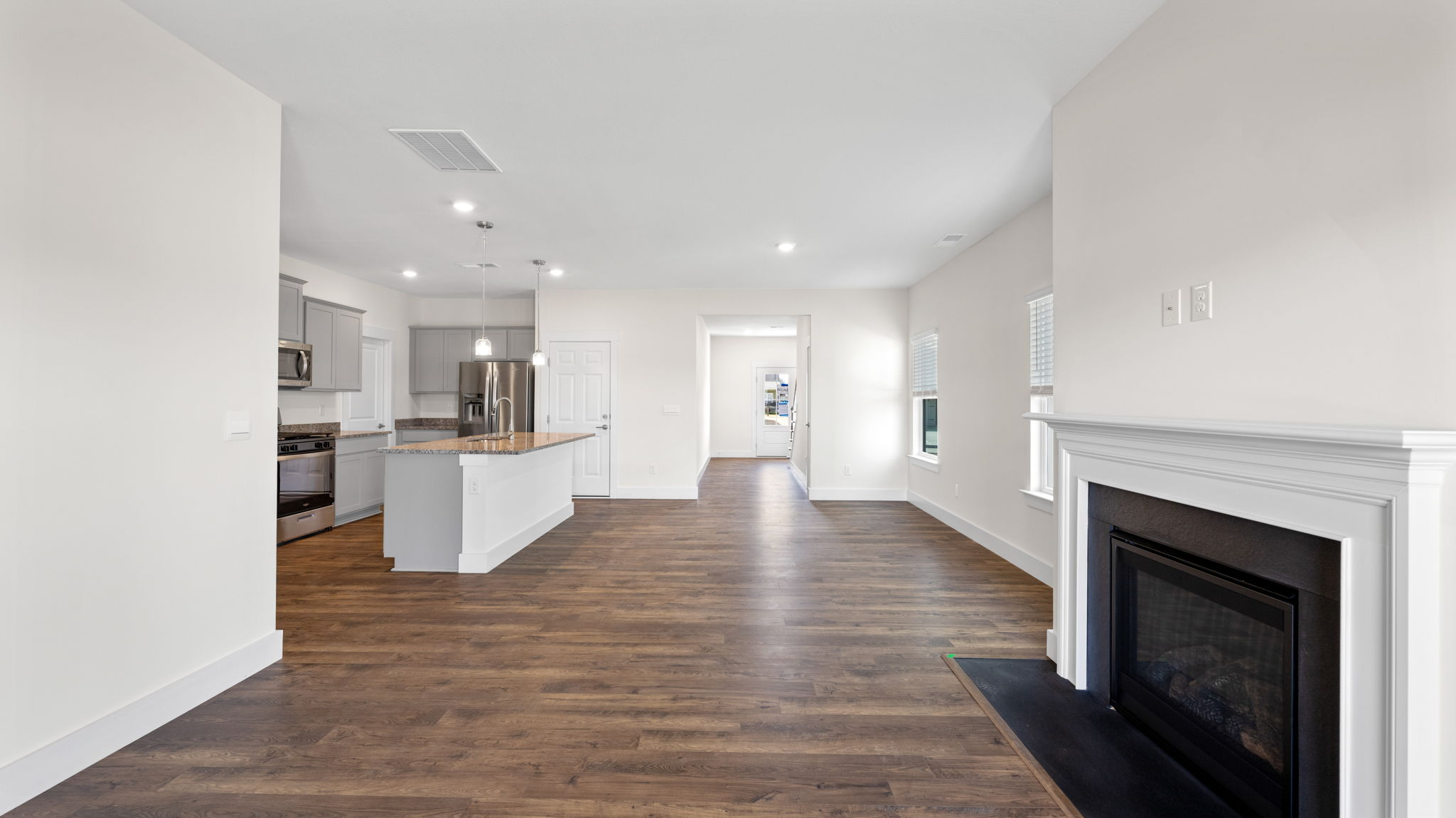 The open living area has a fireplace and recessed lighting.