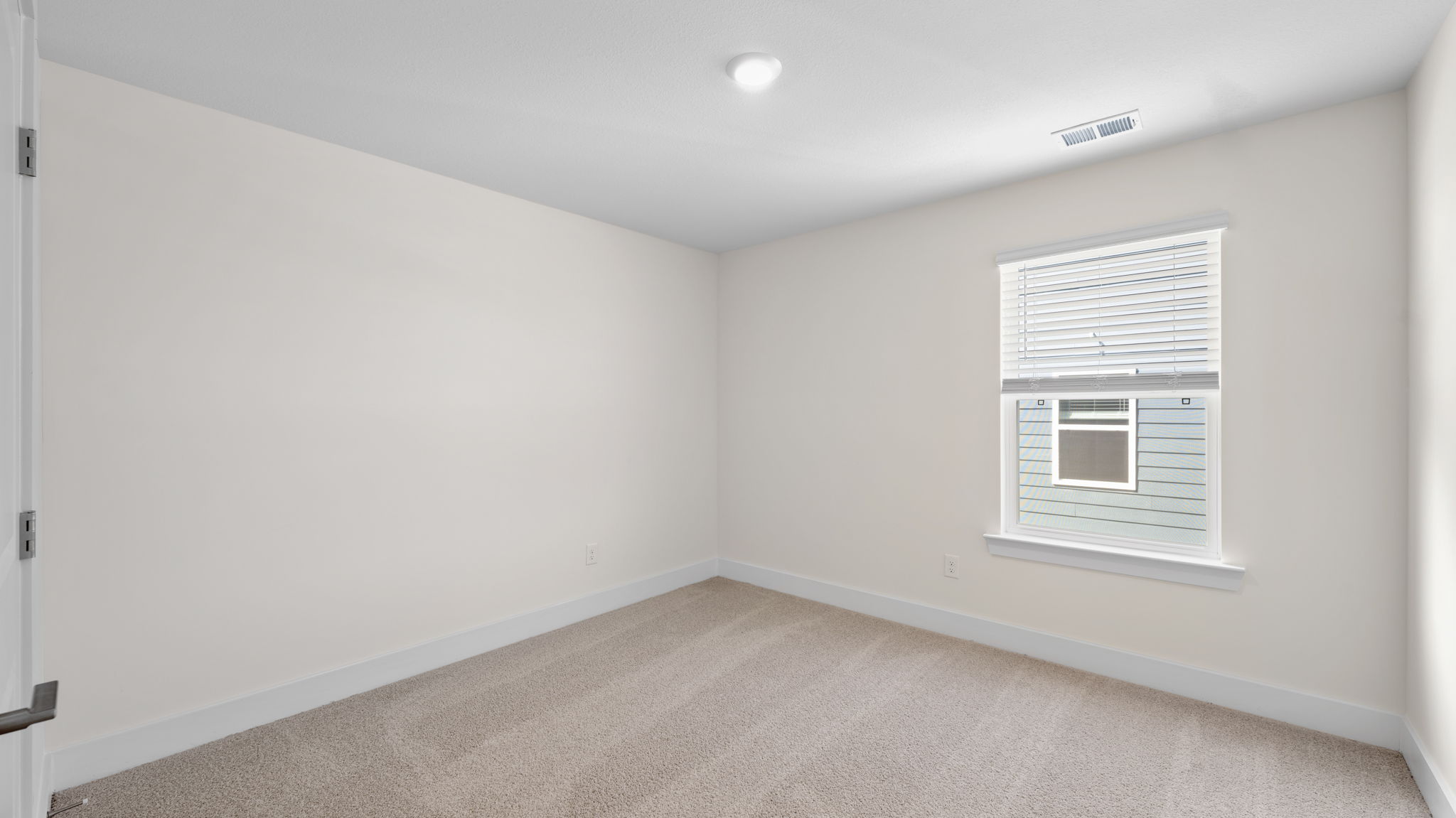 The bedroom has a large window and recessed lighting.