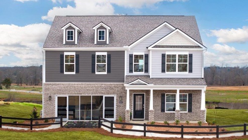 Exterior of two story Columbia model home with light brick and dark gray James Hardie siding