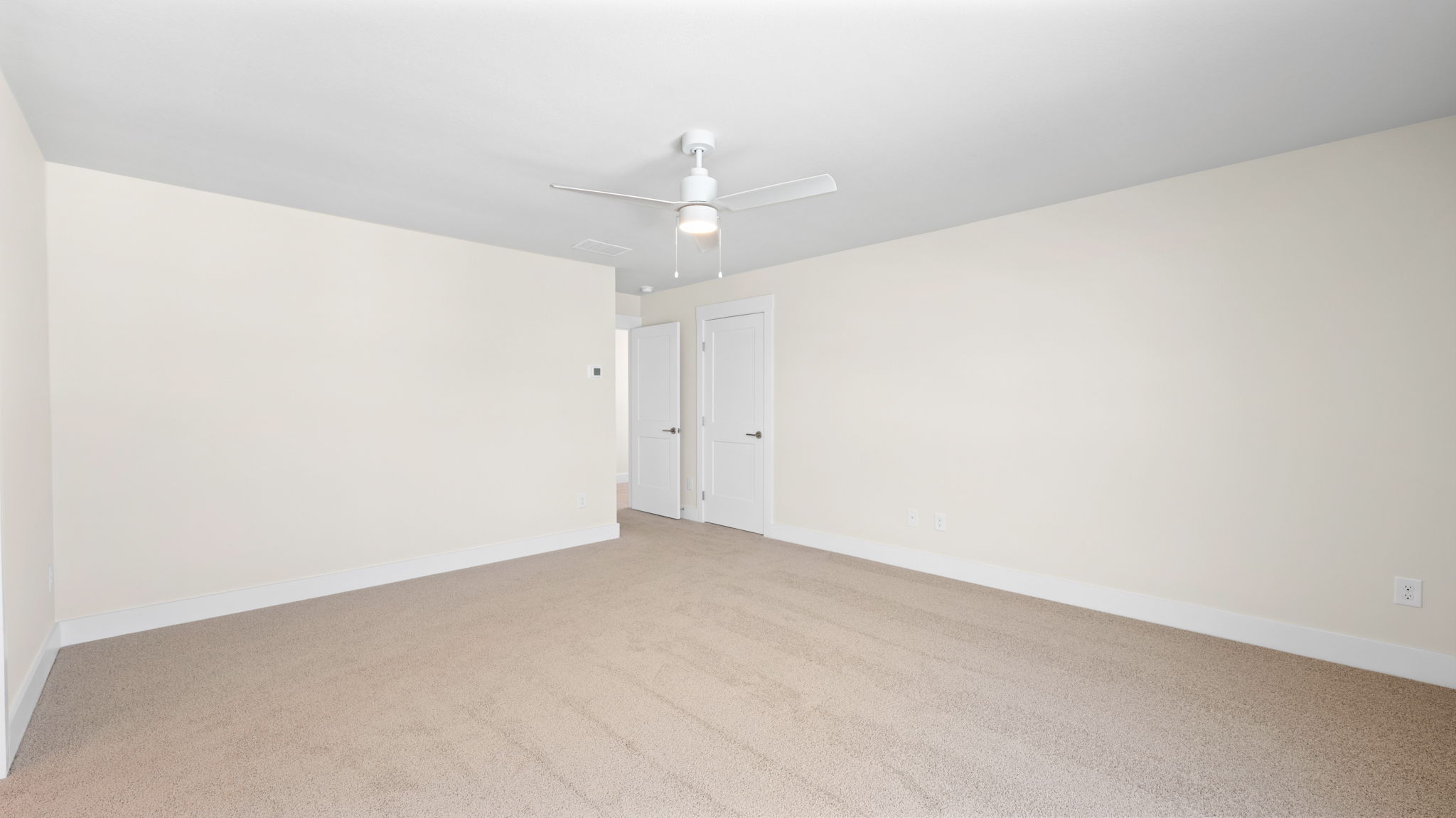 primary bedroom with ceiling fan
