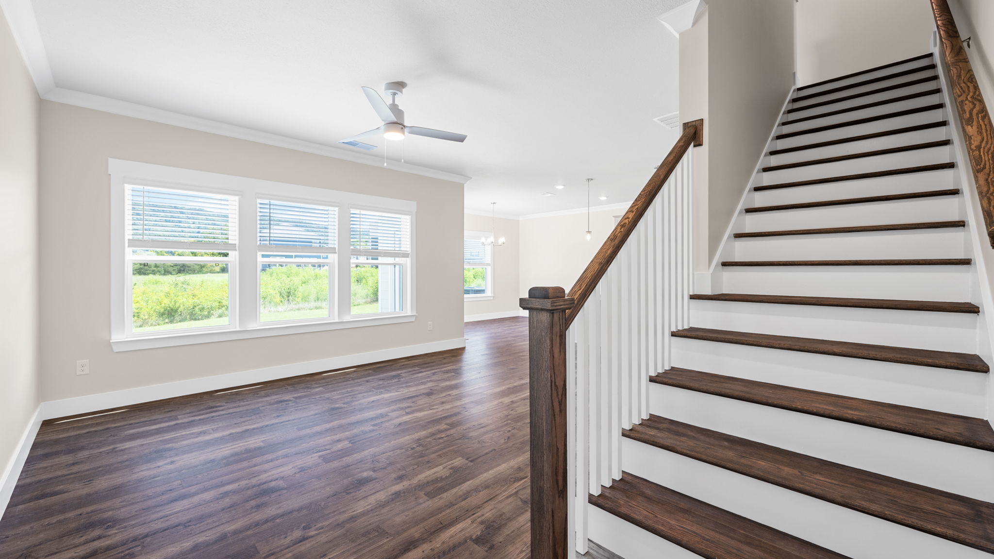 stairs with rev wood flooring to second floor