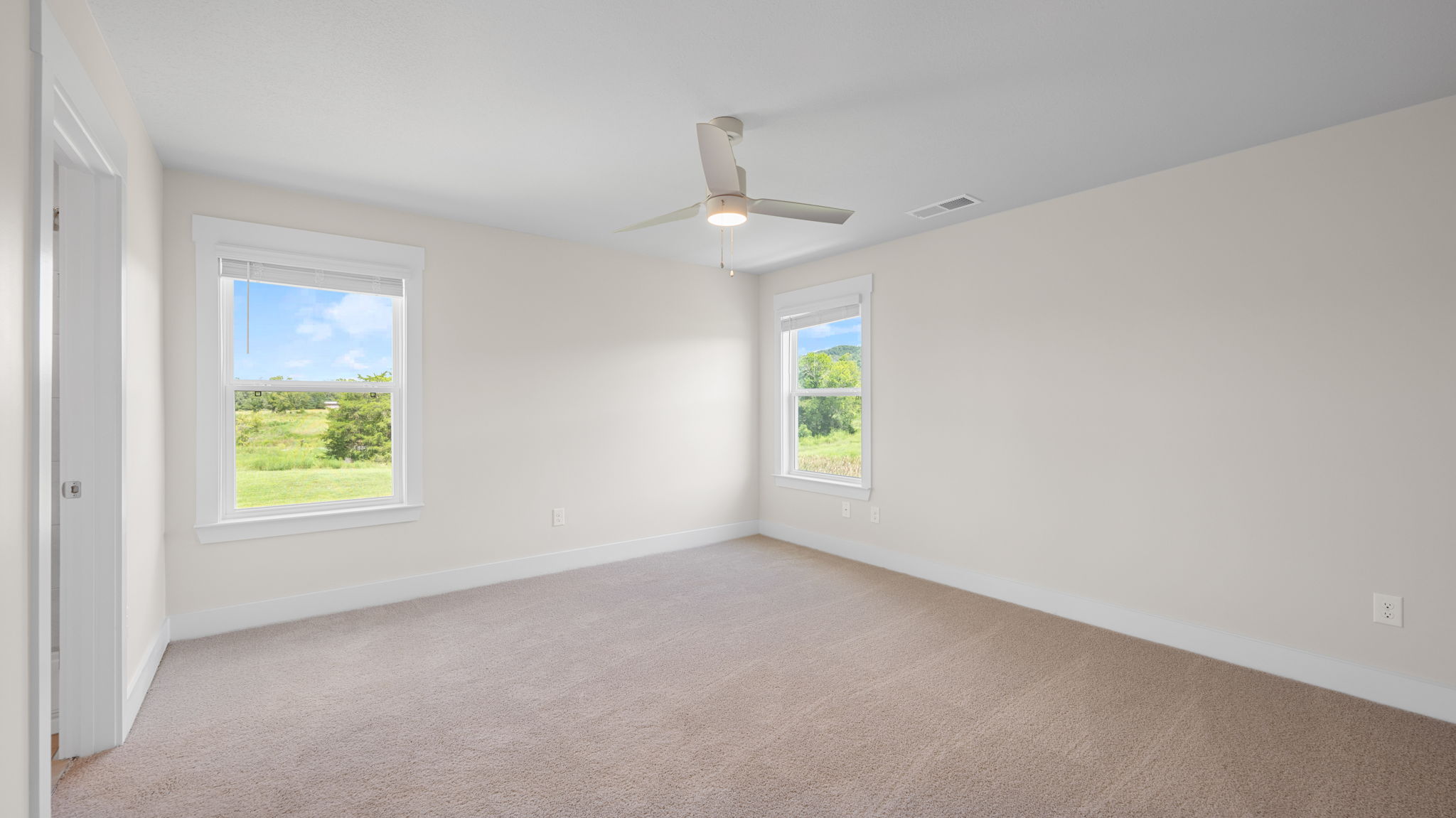 primary bedroom with ceiling fan