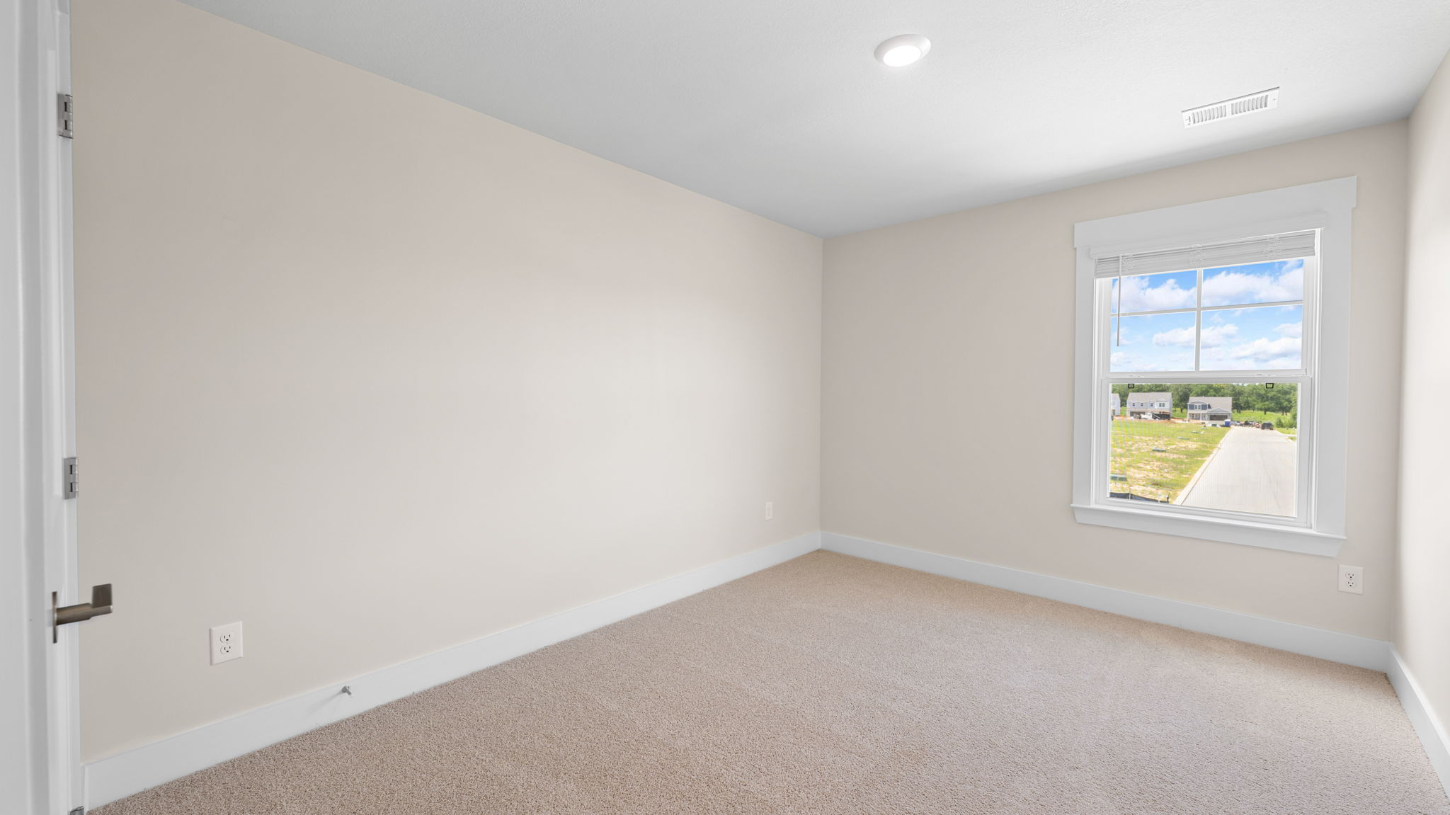 guest room with single window and carpet