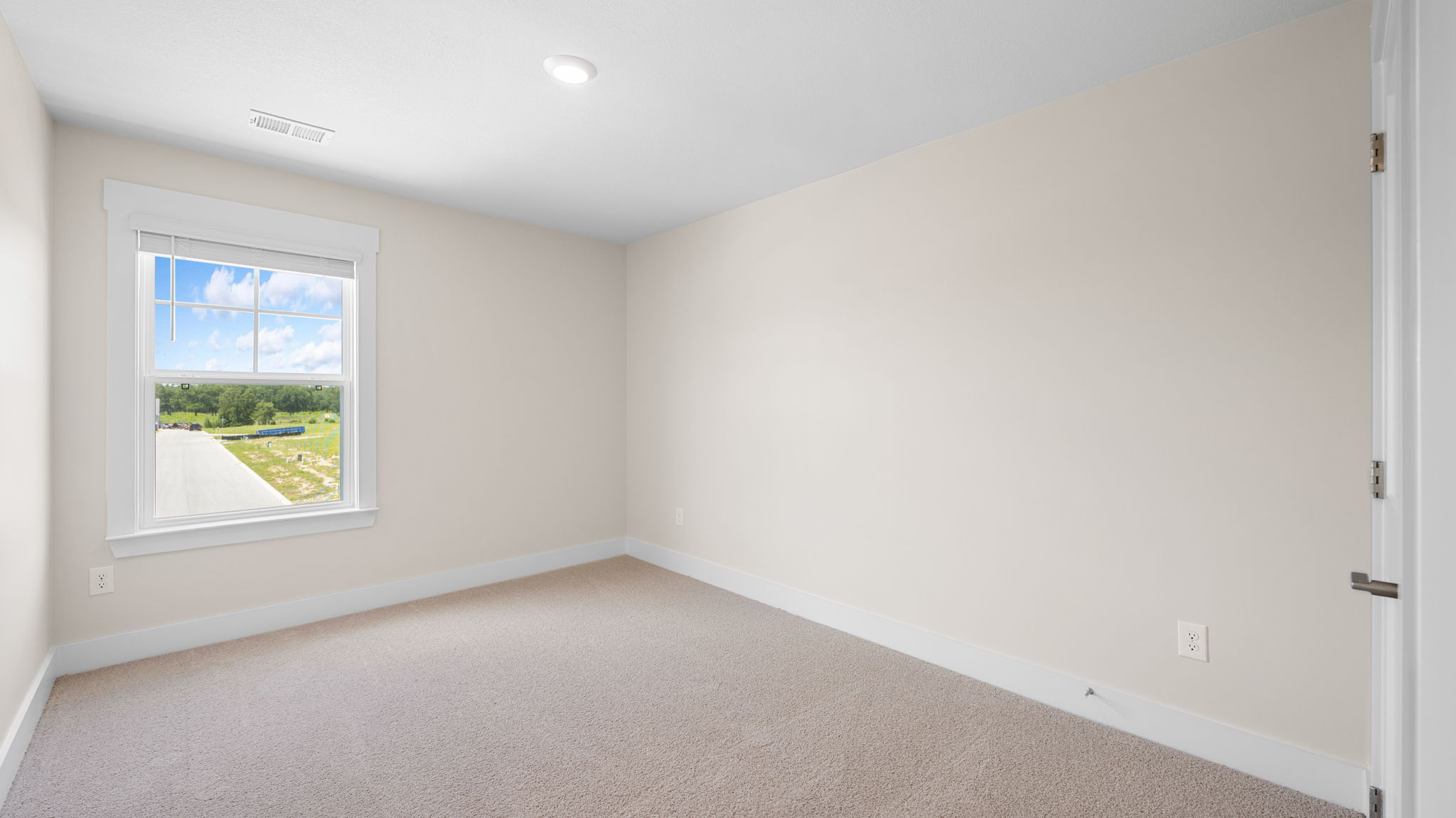 guest room with single window and carpet
