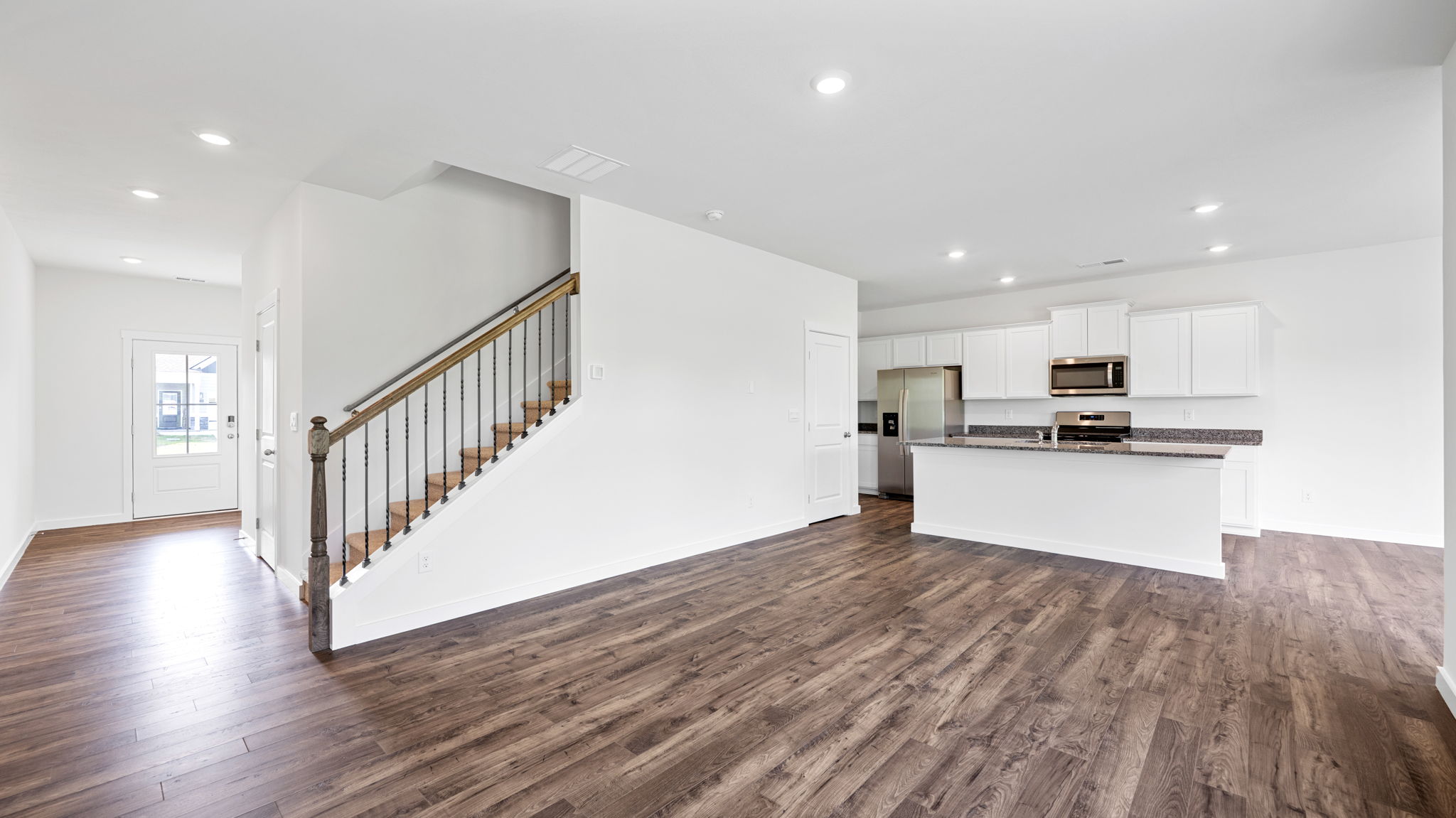the kitchen has solid flooring and opens into the living room