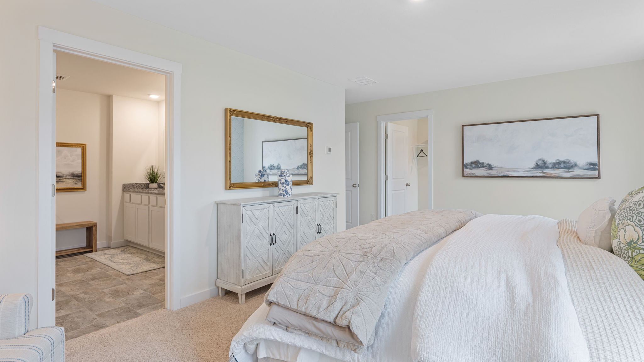 primary bedroom with two single windows and en suite
