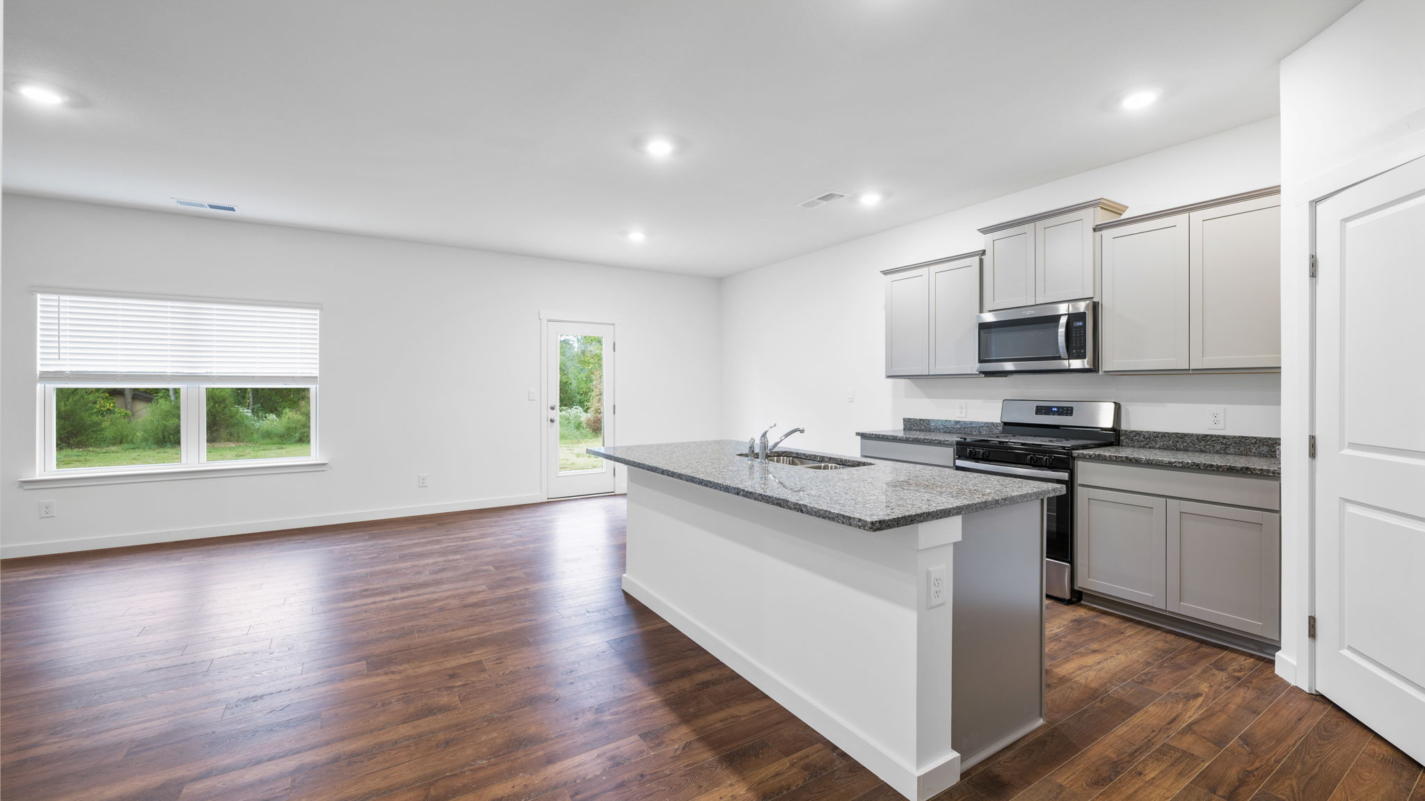 open concept kitchen with large island and stainless steel appliances