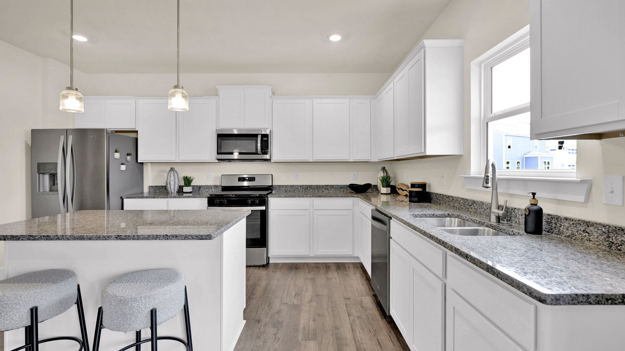 alternate angle of kitchen with two chiars