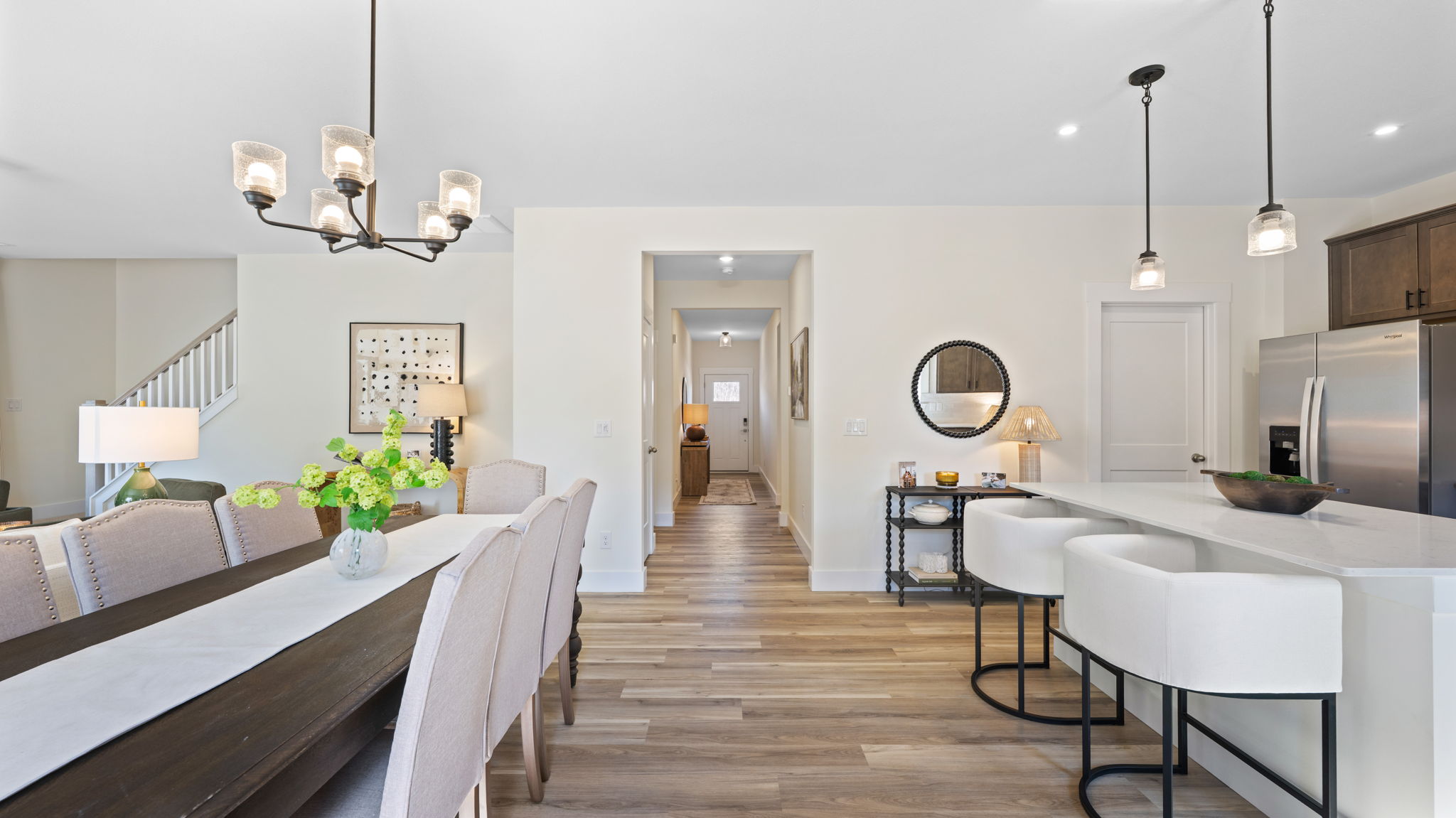Entry ay leads into kitchen with bars seating