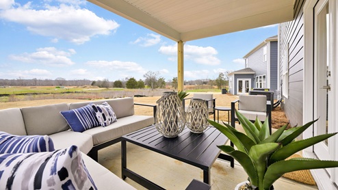 Back patio of model home staged with outdoor living furniture