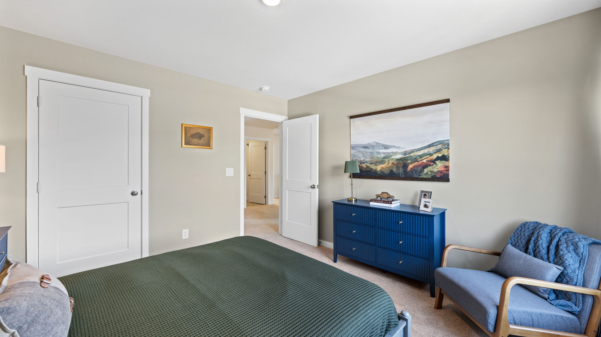 Guest bedroom on second floor with large double window and closet