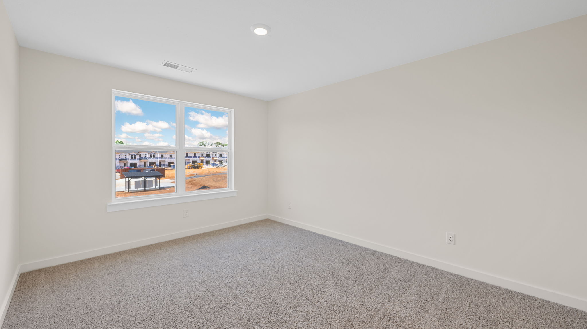 Primary bedroom with carpet and double windows