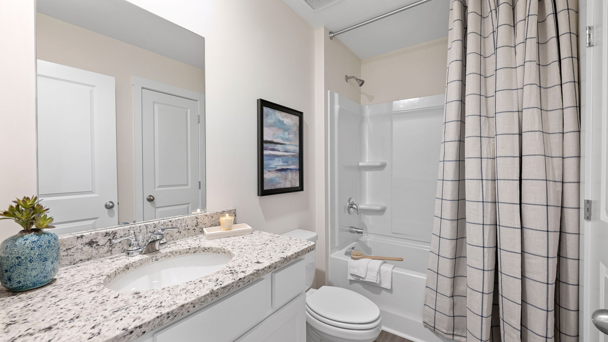 Guest bathroom with single bowl vanity and tub