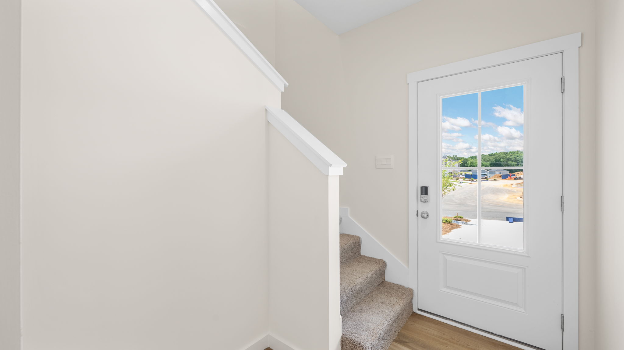 Entryway with carpeted staircase.
