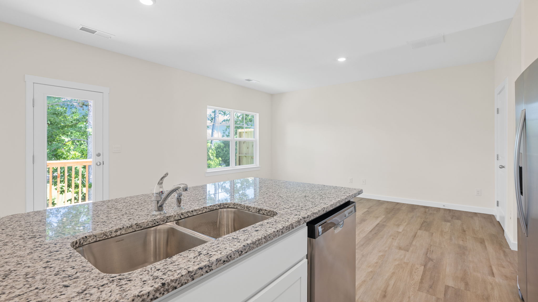 Spacious kitchen with brand new stainless steel appliances connecting to the living area.
