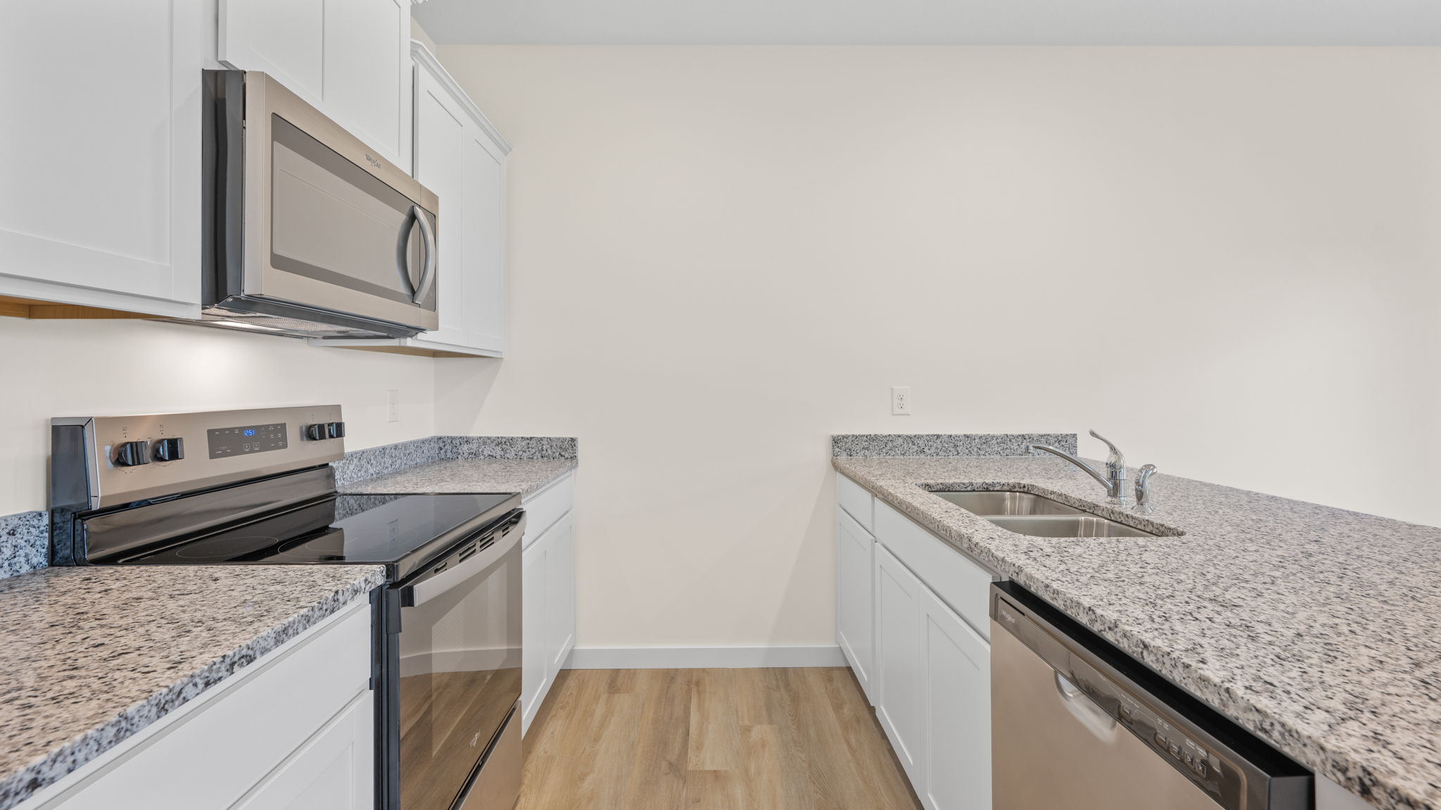 Kitchen featuring brand new stainless steel appliances, cabinets, and a large island.