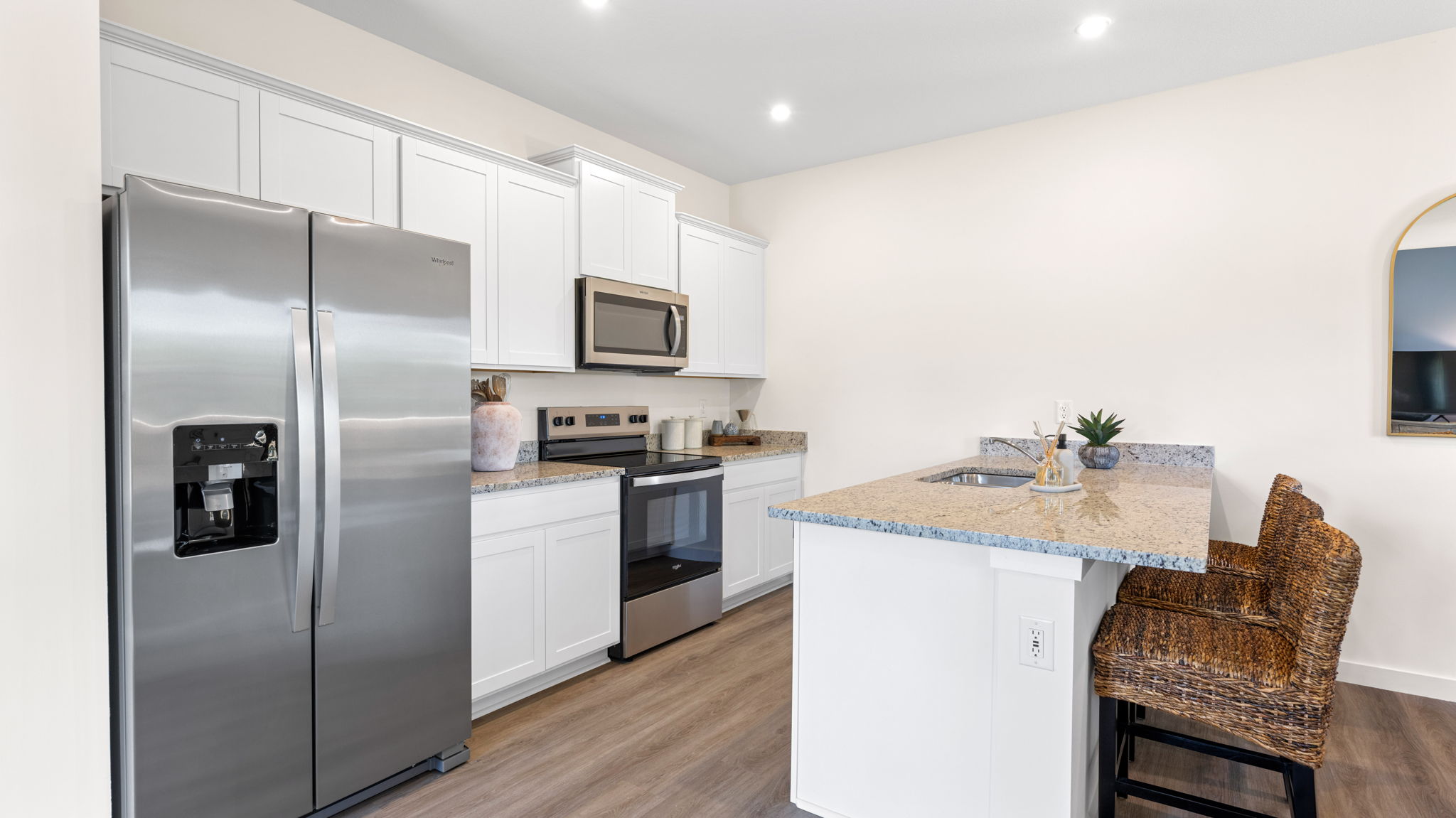 Kitchen with new hard surface countertops and new stainless steel appliances.