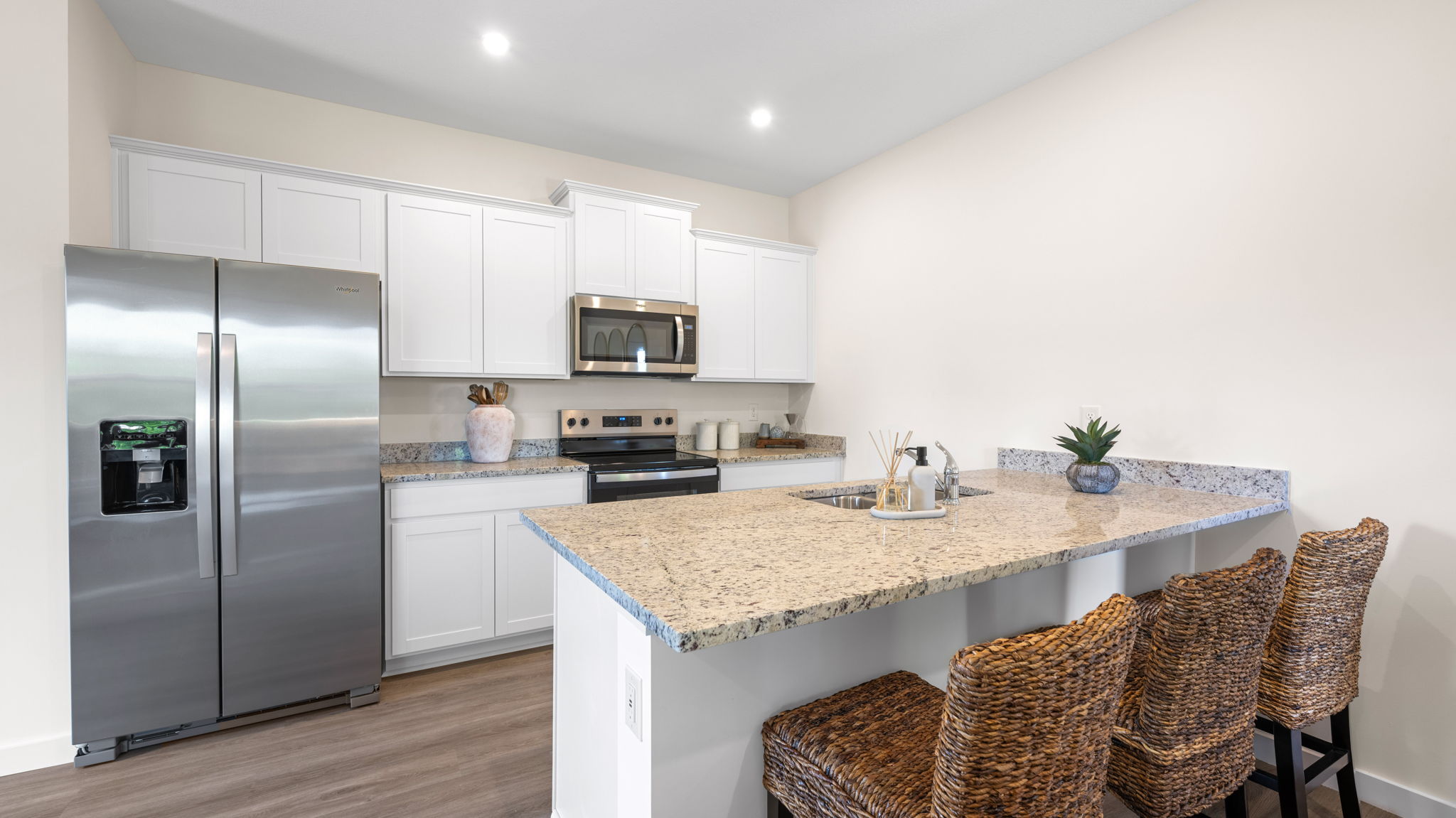 Kitchen featuring cabinets, new stainless steel appliances, and a large standing island.