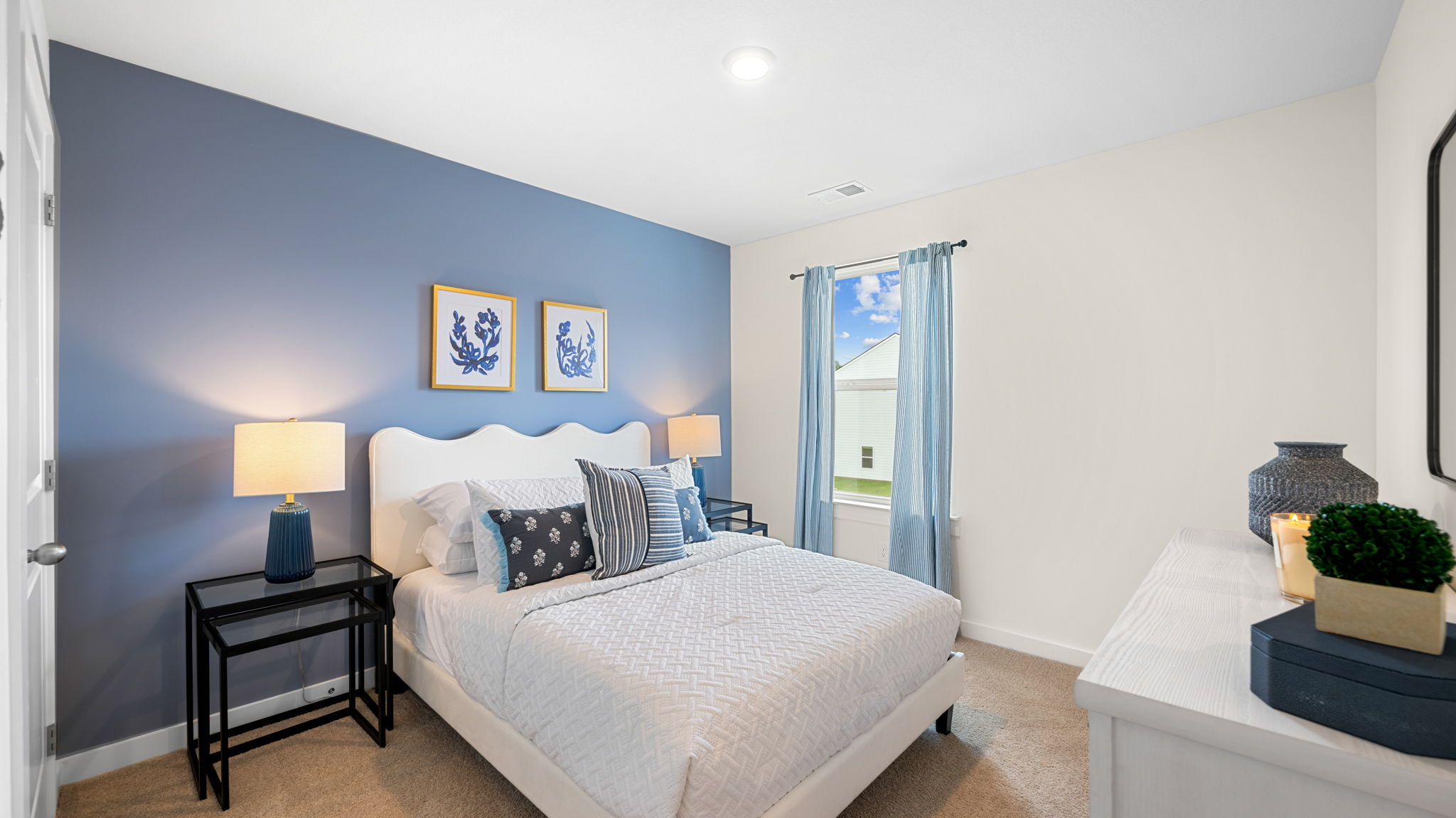 Bedroom with an accent wall and natural lighting.