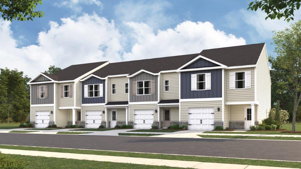 View of townhomes with neutral exteriors and paved driveways.