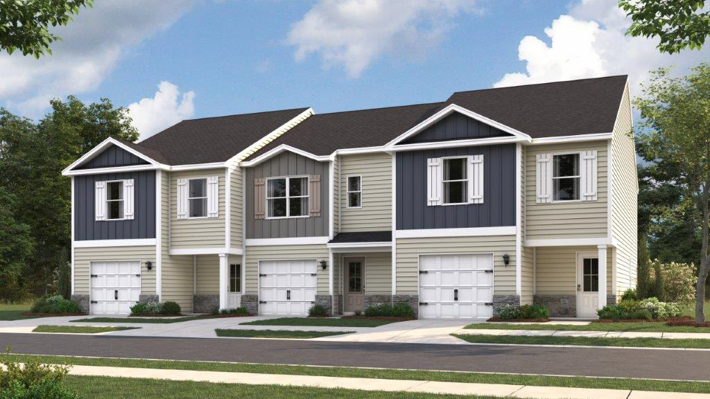 View of townhomes with neutral exteriors and paved driveways.